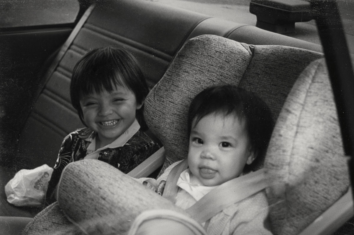 Aki and sister Michelle in the back of a car