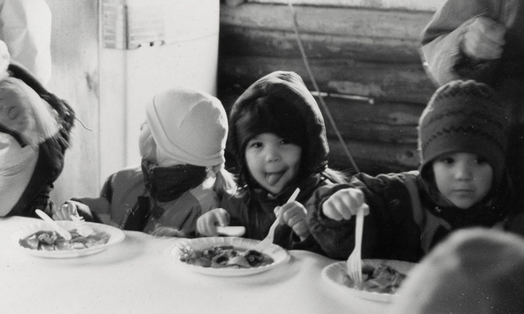 Aki, as a young child, eating a French-Canadian breakfast on a school field trip